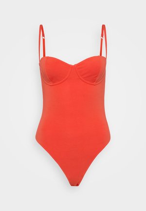 Red one-piece swimsuit with thin straps, a sweetheart neckline, and a smooth, stretchy fabric. Features a high-cut leg design.