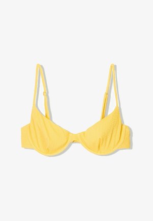 Žlutý bikini top s texturovanou tkaninou, s podpůrnýma kosticema, nastavitelnými ramínky a zapínáním na zádech. Jednoduchý, funkční design.