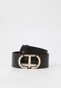 Black leather belt with a wide design, featuring a gold circular buckle with a "T" motif and embossed brand name. Smooth texture.