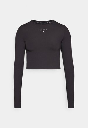 Maglietta nera a maniche lunghe crop realizzata in tessuto elasticizzato. Caratterizzata da un collo rotondo e un logo bianco centrato. Tessitura liscia, forma aderente.