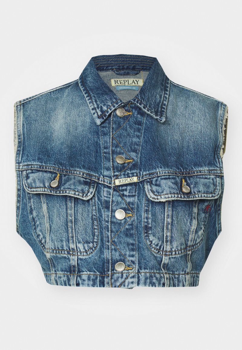 Jeansjacka utan ärmar i urtvättad blå färg, med två framfickor, silverfärgade knäppningar och synliga sömnadsdetaljer. Märkesetikett inuti kragen.