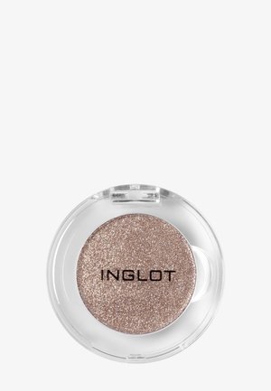 Contenant rond en plastique transparent contenant un fard à paupières or rose scintillant avec "INGLOT" imprimé sur la surface du maquillage.