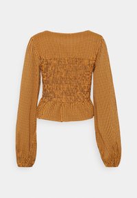 Long-sleeve, cropped blouse in orange and black gingham pattern. Features smocked back, elasticized sleeves, and a peplum hem.