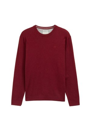 Suéter burdeos de cuello redondo fabricado en un material suave. Mangas largas y puños acanalados con un pequeño detalle del logo en el pecho. Textura lisa.