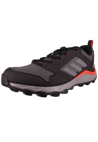 Men's athletic shoes with a black synthetic upper, grey accents, and red details. Features textured mesh, rubber outsole, and lace closure.
