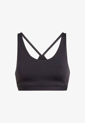 Sujeción deportiva negra con tirantes finos que se cruzan en la espalda y una banda inferior ancha y de soporte justo debajo del busto.