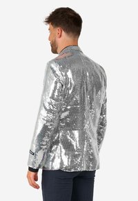 Silver sequined blazer with a structured fit, featuring a notch lapel and single button closure, displayed from a rear angle.