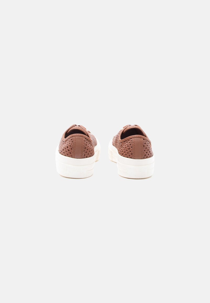 Brown woven slip-on sneakers with white thick rubber soles viewed from the back on a plain light background.