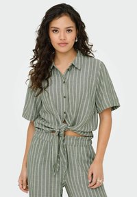 Groen gestreepte korte mouwen overhemd met knoop aan de voorkant, gecombineerd met bijpassende broek met elastische tailleband en gestreept patroon.