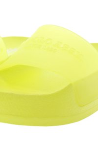 Yellow transparent slide sandal with a textured footbed and two wide straps. Featuring raised logo on the strap and a durable sole.