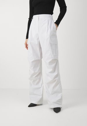 White cargo pants made of lightweight fabric with a loose fit, featuring a high waist, large side pockets, and a smooth, matte texture.