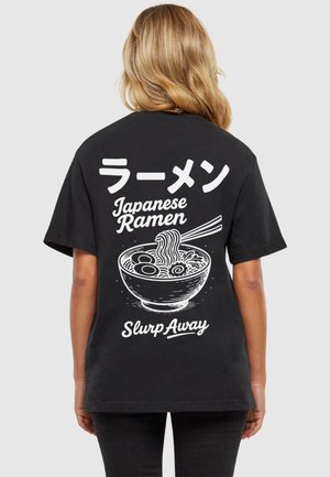Čierne tričko s bielou grafikou misky ramenu, textom v japončine a angličtine, a vo voľnom strihu. Krátke rukávy a mäkká textúra.