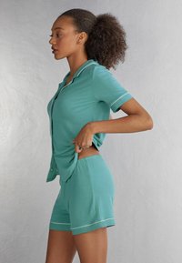 Intimissimi AUS MIT KANTEN IN KONTRA  - Pyžamový spodní díl - blau lagoon blue