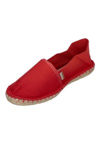 Red canvas espadrille with a flat silhouette, stitched rope sole, and elasticized opening. Features a small brand label on the side.