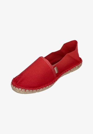 Red canvas espadrille with a flat silhouette, stitched rope sole, and elasticized opening. Features a small brand label on the side.