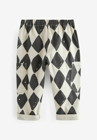 Black and white patterned cotton pants featuring a diamond design, elastic waistband, rolled cuffs, and two side pockets.