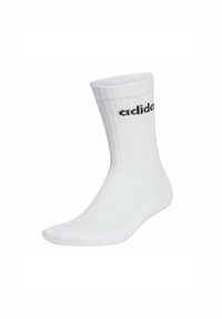 Chaussette en coton blanc à tige droite avec un motif côtelé et un logo noir imprimé sur le côté. Sections de l'orteil et de la cheville lisses pour le confort.