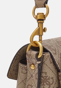 Sac à main textur�é marron présentant un fermoir et des accessoires en métal doré, des coutures contrastantes foncées et une forme structurée.