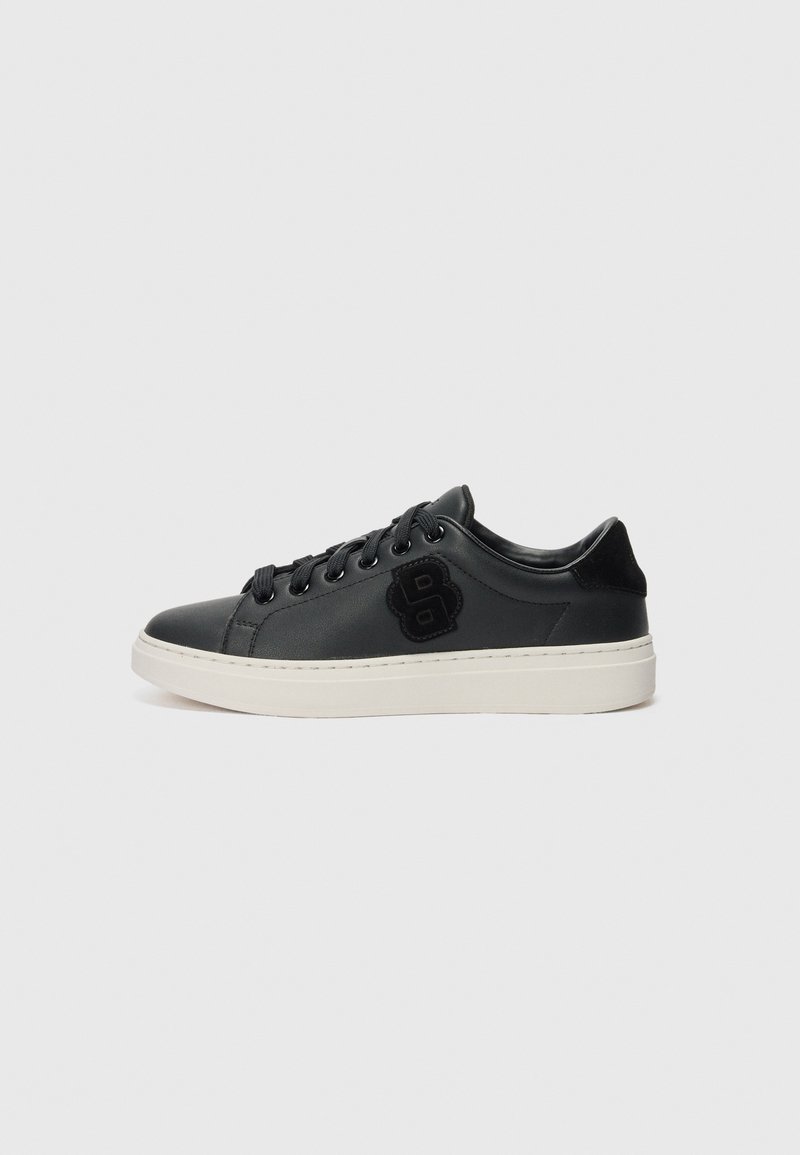 Black synthetic low-top sneakers with a smooth texture, white sole, and black logo on the side. Features black laces and minimal design.