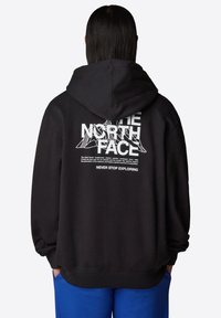 Zwarte hoodie van een katoenmengsel met een trekkoord capuchon. Heeft witte grafische tekst en een bergontwerp op de achterkant. Geribbelde manchetten en zoom.