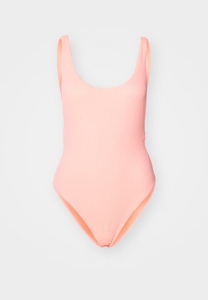 Enodelni kopalke v mehki breskevni barvi, teksturirano blago z širokimi naramnicami, okroglo ovratnikom in visokimi razporki. Gladka notranja podloga.