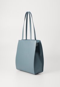 Blue leather tote bag with dual shoulder straps, rectangular shape, smooth texture, and a zippered compartment on the side.