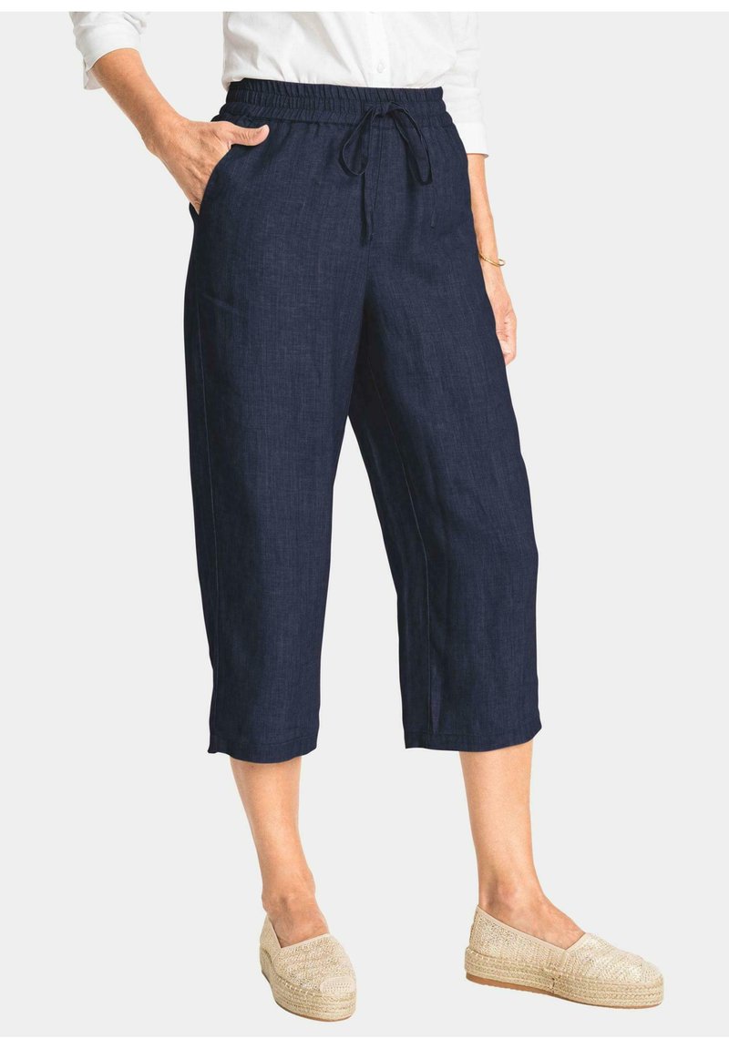 Marineblauwe cropped broek met een elastische taille en een trekkoord. Gemaakt van een gestructureerde stof, met zijzakken en een ontspannen pasvorm.