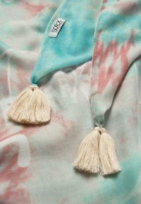 Lightweight scarf featuring a tie-dye pattern in shades of light blue, pink, and cream; finished with two cream tassels at each end.