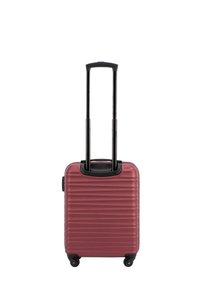 Valise rigide de couleur bordeaux avec des rainures horizontales, poignée noire rétractable, quatre roues et une poignée supérieure robuste pour le transport.