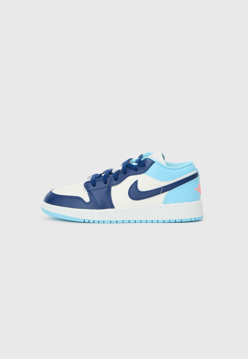 Nike sneakers featuring a white leather upper with navy blue accents, light blue details, and a rubber sole. Includes prominent swoosh logo.