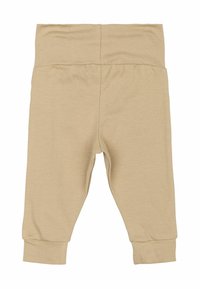 Bež otroške pajkice iz mehkega, raztegljivega bombaža. Imajo elastični pas in zožene manšete pri gležnjih. Brez žepov.