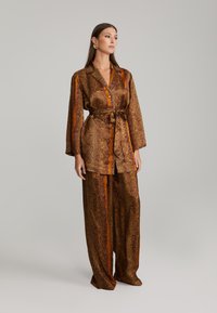 ANDIATA KARIE - Pantaloni - orange/brown