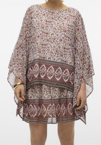 Kafran à motif floral en tissu transparent, avec une coupe ample, un col rond et un ourlet à couches avec une bordure contrastante et des couleurs accentuées.