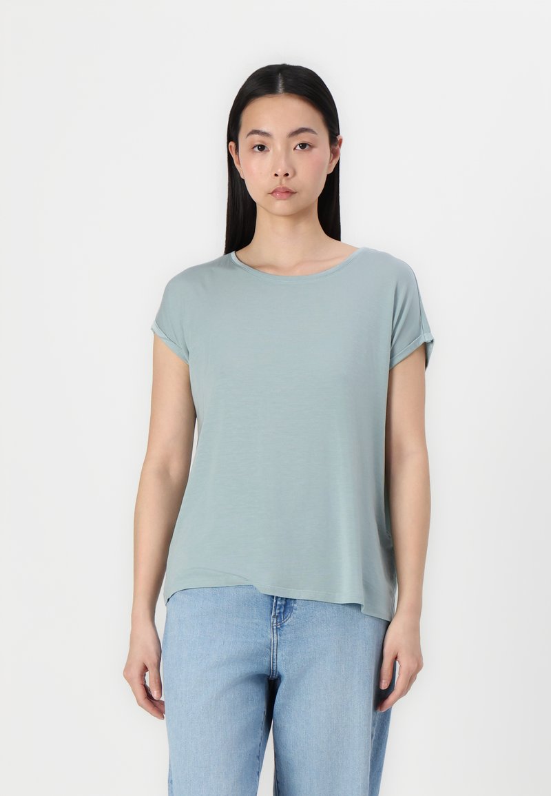 Lyseblå, kortærmet t-shirt i blød, åndbar stof med rund halsudskæring og afslappet pasform, parret med lyseblå jeans.