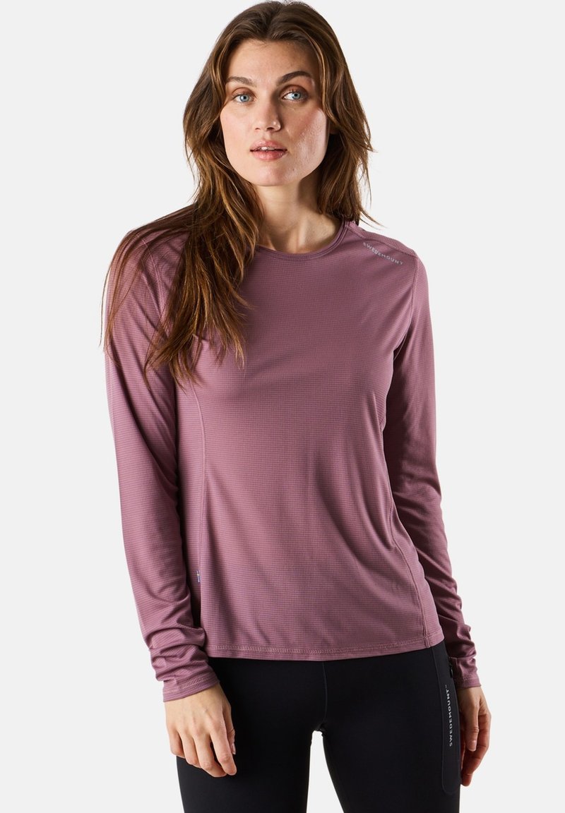 Langsleeve sporttop in gedempt mauve, met een textuurstof, ronde halslijn en subtiele logodetail op de schouder.