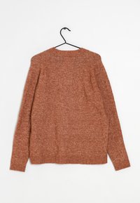 Brown knitted sweater with a textured finish, featuring long sleeves, a round neckline, and ribbed cuffs and hem. Hangs from a black hook.