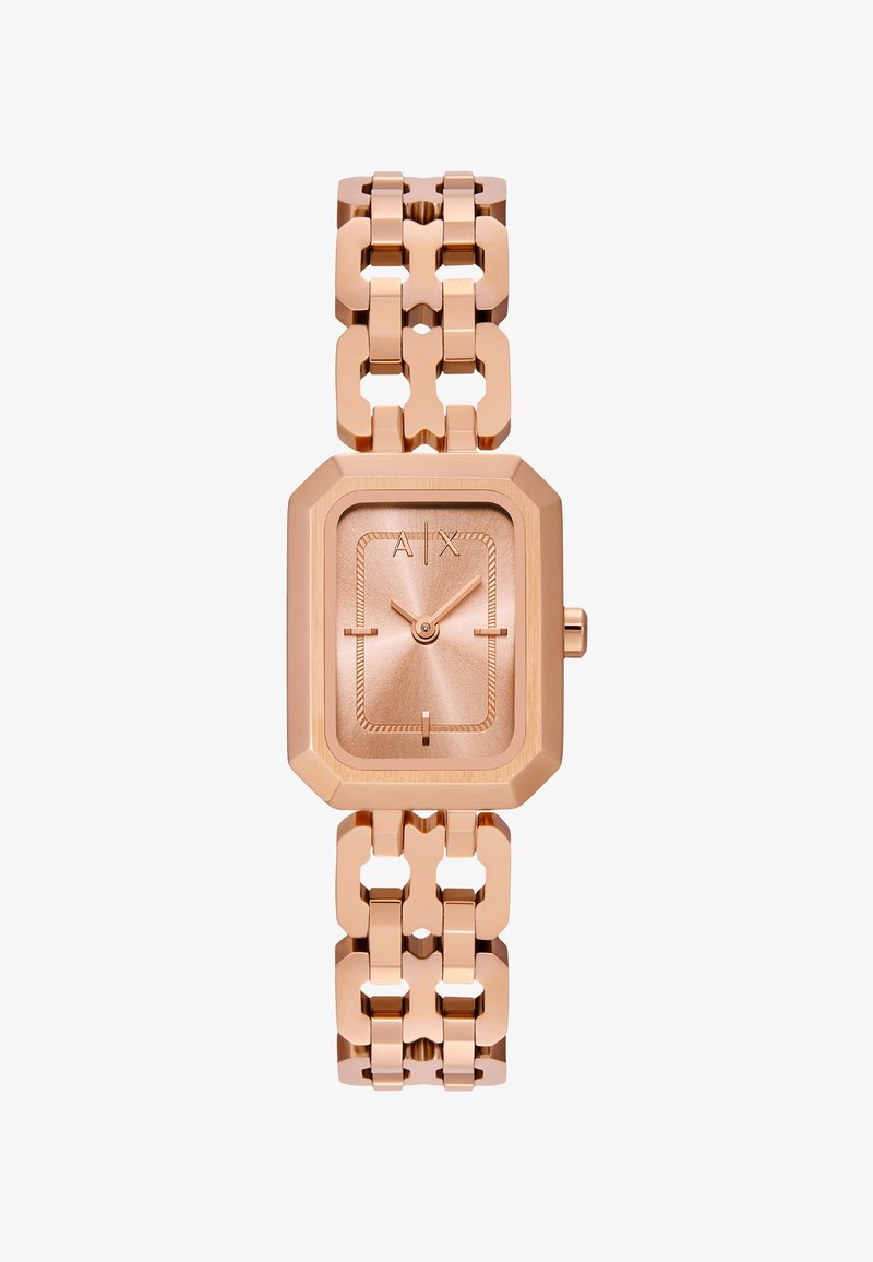 Roosa kuldne kell, millel on ristkülikukujuline korpus, tekstuuriga kellatempel ning linkpael, millel on lõigatud aksessuaarid. Lihtsad tunni näitavad markeerijad ja peened näpud.