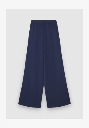 Pantalon large marine avec ceinture élastique, fabriqué en tissu doux. Caractérisé par une coupe ample et un ourlet net et épuré.
