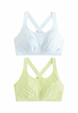 Two seamless sports bras with crossed straps, one white and one pale yellow, displayed flat on a white background.