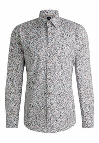 Chemise à manches longues en tissu gris clair avec des motifs floraux colorés, col à boutonnière et boutons marron pour la fermeture.