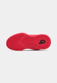 Sole di scarpa da ginnastica rossa con un motivo di grip testurizzato e un logo stilizzato "P" nero vicino al tallone su uno sfondo bianco.