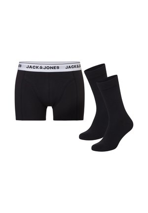 Zwarte herenboxershort met een witte tailleband met het merk "JACK & JONES", gecombineerd met een paar effen zwarte enkelsokken.