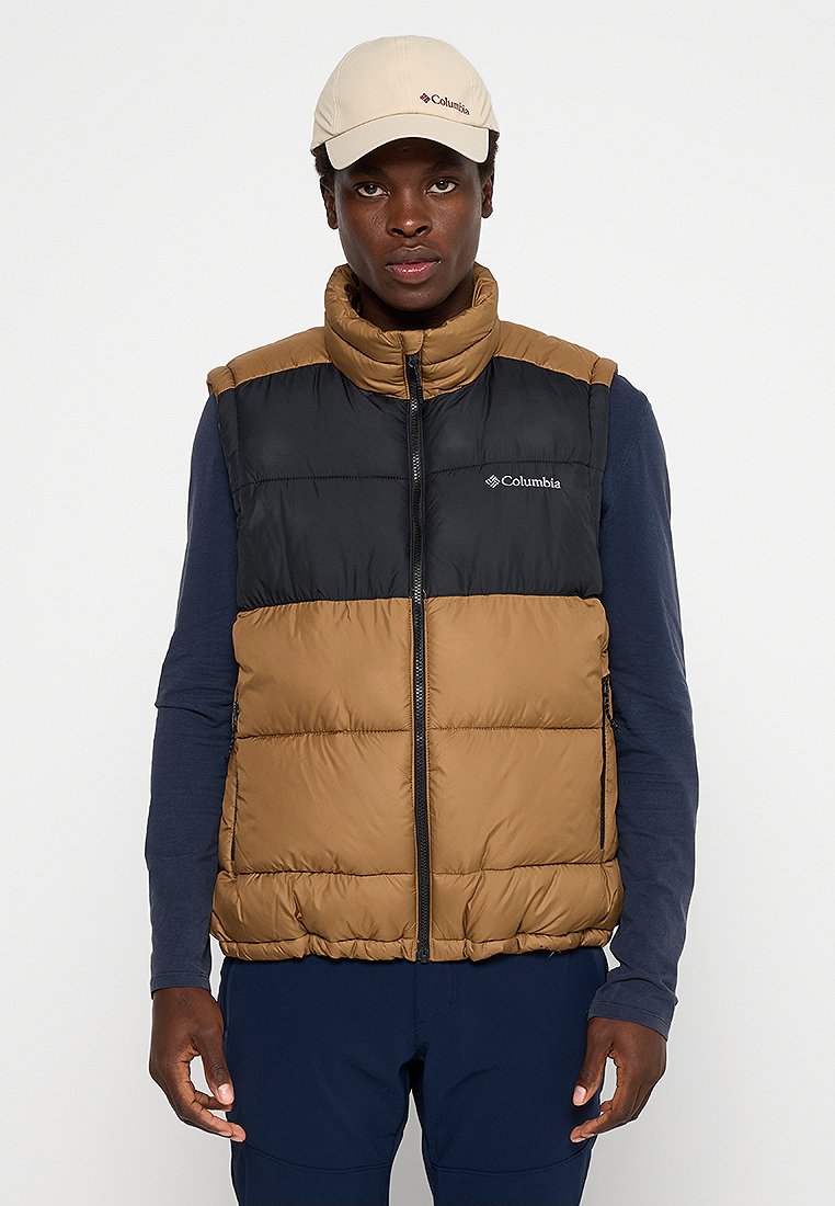 Kamizelka z wypełnieniem, z czarną górą i brązowym dołem. Posiada wysoki kołnierz, zamek błyskawiczny z przodu oraz detal z logo po lewej stronie klatki piersiowej.