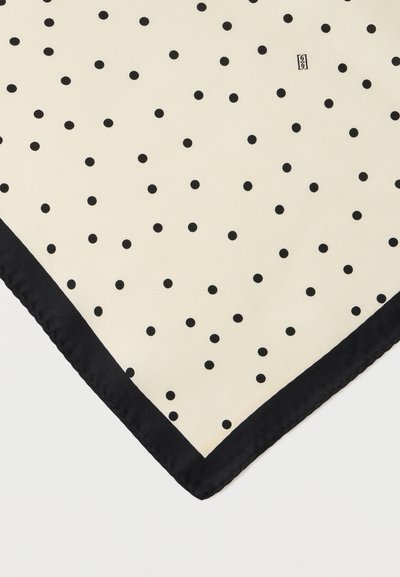 Ύφασμα εκρού με μικρές μαύρες πουά σε ομοιόμορφη διάταξη και στενή μαύρη περίμετρο κατά μήκος της άκρης.