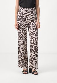 Wide-leg pants made of light fabric, featuring a beige base with a brown zebra stripe pattern. The waistband is high, with a smooth finish.