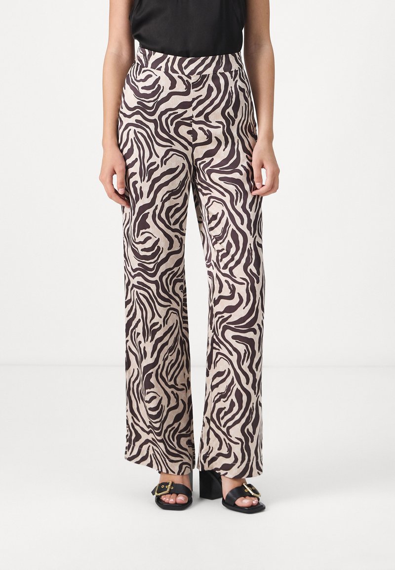 Wide-leg pants made of light fabric, featuring a beige base with a brown zebra stripe pattern. The waistband is high, with a smooth finish.