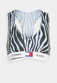 Svart och ljusblå zebra-mönstrad bralette med racerback-design, mjukt tyg och ett elastiskt vitt band med varumärkets logotyp.