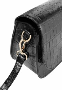 Czarna torebka z syntetycznej skóry krokodyla o błyszczącym wykończeniu, z zapięciem w złotym kolorze i teksturowanym paskiem. Kompaktowy, prostokątny kształt.