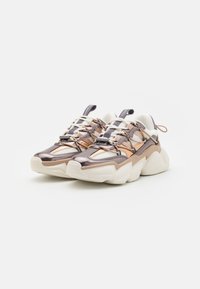 Chunky sneakers with a metallic copper and bronze upper, textured fabric panels, white accents, and a thick, cushioned sole.