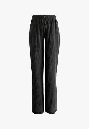 Loose black crinkled fabric pants with elastic waistband and adjustable drawstring, straight leg fit.